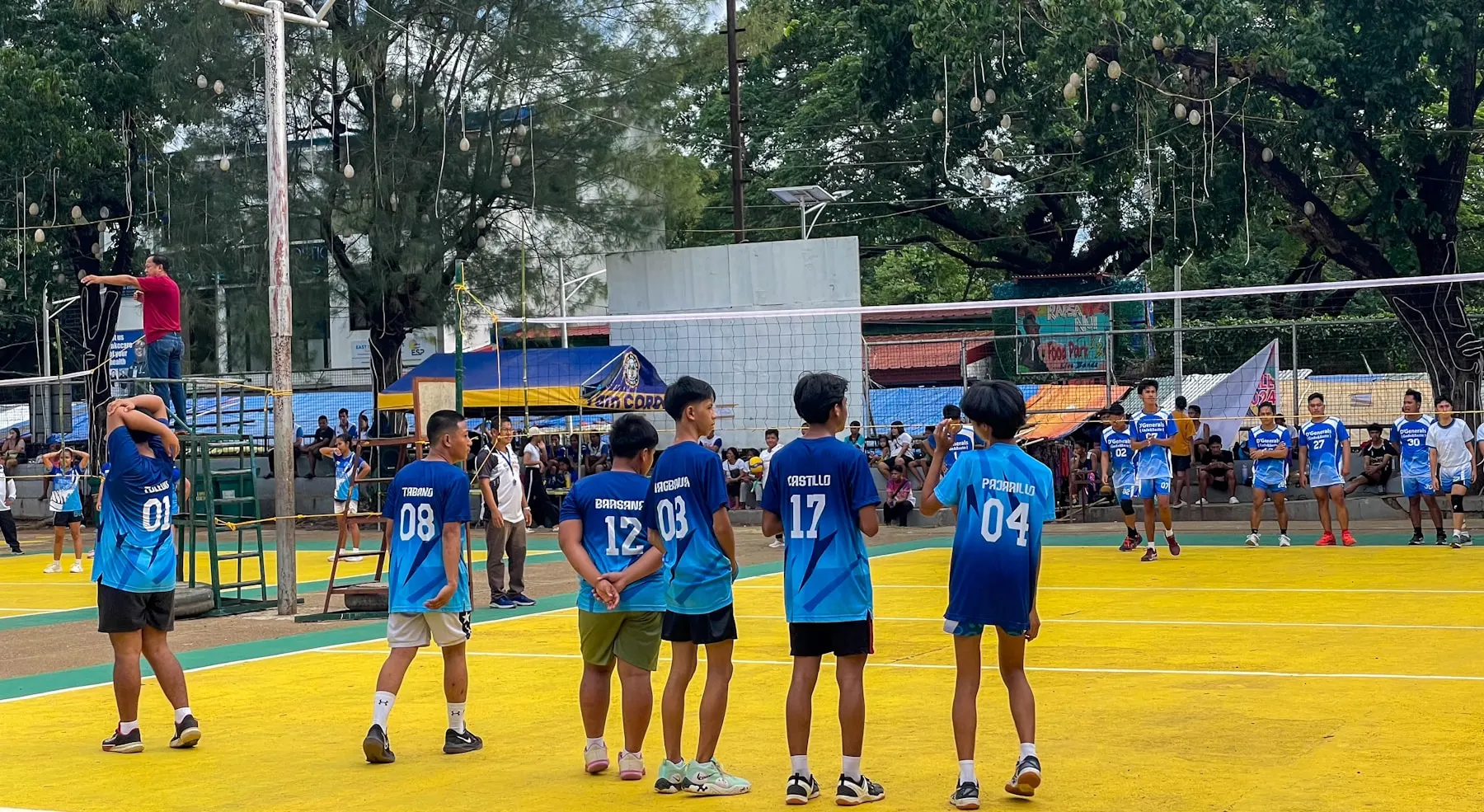 Youth volleyball athletes competing on an outdoor court